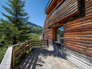 a wooden deck next to a building with a window at Chalet d'exception à Avoriaz, 12 personnes, 7 pièces, ambiance alpine - FR-1-314-306 in Avoriaz
