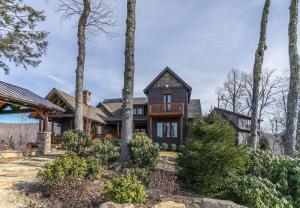 an exterior view of a house with trees at Elk Camp Lodge in Linville