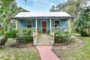 a blue house with a red door and stairs at Little Blue Cottage in St. Augustine +39 photos