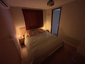 a bedroom with a bed with two towels on it at Chaletpark de Kempenbos - 196 in Westelbeers