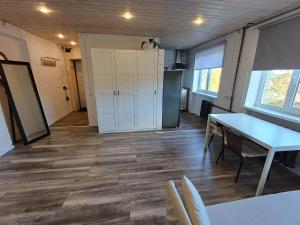 a room with a table and chairs and a kitchen at Two room apartment near buss station and border in Narva +6 photos