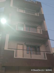a building with balconies on the side of it at sahithya comfort homestay in Bengaluru