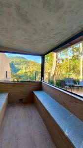 a room with a large window with a view at Casa 08 Floresta Boa Vista - Piscina Privativa e Lounge com Deck em Meio à Natureza in Teresópolis
