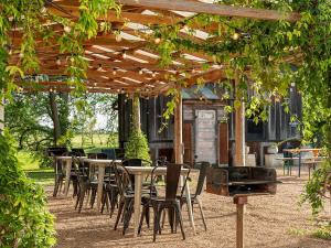 a group of tables and chairs under a pergola at Camp Comfort in Comfort