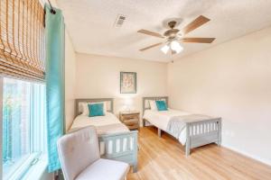 a bedroom with two beds and a ceiling fan at Modern Bentonville Retreat - Sleeps 6 Near Trails in Bentonville