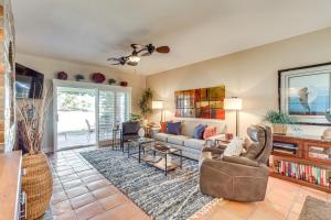 a living room with a couch and a table at Golf Course View and Pool Access Palm Desert Condo in Palm Desert Country