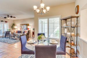 a dining room and living room with a table and chairs at Golf Course View and Pool Access Palm Desert Condo in Palm Desert Country