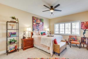 a bedroom with a bed and a ceiling fan at Golf Course View and Pool Access Palm Desert Condo in Palm Desert Country +30 photos