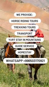 a person riding a horse in a field at Travel Around Guest House in Kochkor