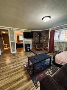 a living room with a couch and a fireplace at Fall Getaway in Auvinen Corner
