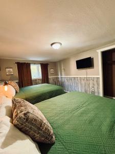 a bedroom with two beds and a flat screen tv at Fall Getaway in Auvinen Corner