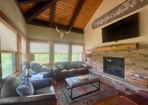 Una sala de estar con un sofá y una chimenea. en Mountain View Penthouse Condo with Loft, Pool, and Hot Tub, en Breckenridge