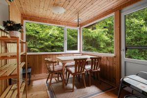 a dining room with a table and some windows at VAS109-Kalv-Roesarp-Sperlingsholm-203 in Kalv