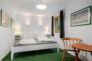 a bedroom with a bed and a table and a chair at VAS109-Kalv-Roesarp-Sperlingsholm-203 in Kalv