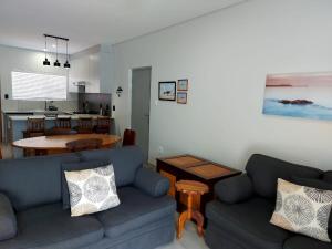 a living room with two blue couches and a kitchen at Unit 48 1onYork in George