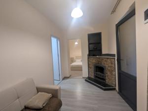 a living room with a couch and a fireplace at Parkside Residences in Tbilisi City
