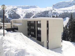 a building on top of a snow covered mountain at Appartement spacieux au centre, balcon, proche pistes, 6 pers - FR-1-425-229 in Arâches-la-Frasse