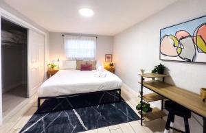 a bedroom with a large white bed and a desk at Chic & Stylish House In Tampa Ybor&busch in Tampa