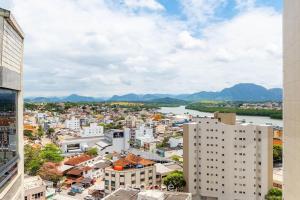 a view of a city with a river and buildings at Apto c/ 2 Quartos a 400 m da Praia INA1306 in Guarapari