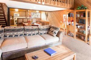 a living room with a couch and a table at Snowcreek #059 Near Shuttle & Activities in Mammoth Lakes