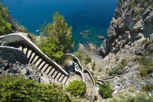 a set of stairs on a mountain next to the ocean at Grand Hotel Tritone in Praiano