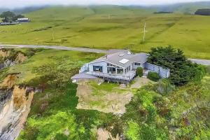 an aerial view of a house on the side of a cliff at Seaside Elegance Oceanfront Escape with 3 Suites in Carmet
