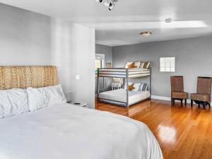 a bedroom with a white bed and two chairs at Seaside Elegance Oceanfront Escape with 3 Suites in Carmet +53 photos