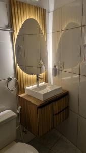 a bathroom with a sink and a mirror at Casa Colonial 3 Suites na Urca - Rio de Janeiro, Vista Baía Guanabara e Vista Pão de Açucar in Rio de Janeiro