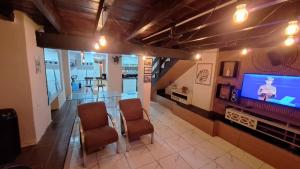 a living room with a glass table and a television at CENTRO DO PELOURINHO in Salvador