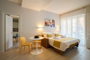 a bedroom with a bed and a table and chairs at Leila's home forever - casa vacanze in Bergamo