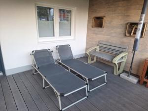 two chairs and a bench on a porch at Apartment in Beratzhausen in Beratzhausen