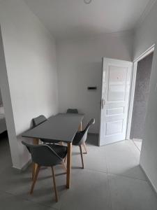 a room with a table and two chairs and a door at Alojamiento Madariaga 224 in Goya