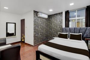 a hotel room with a bed and a window at Townhouse Oak Q-City Techno Park in Hyderabad