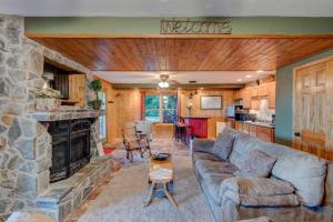 a living room with a couch and a stone fireplace at A Big View in Seven Devils