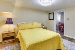 a bedroom with a yellow bed with a yellow bedspread at Fish and Explore Port Arthur Apt Near Sabine Lake! in Port Arthur
