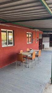 a table and chairs in front of a building at CASA GRANDE FINCA EL CALABRES in Agüimes +40 photos