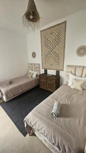 a bedroom with two beds and a wall at Riad Laila Marrakech in Marrakesh +52 photos