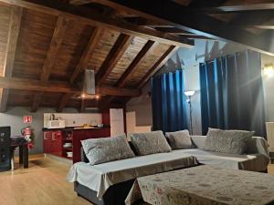 a living room with a couch and blue curtains at Aiestaenea Apartamentos Rurales in Isaba