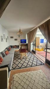 a living room with a couch and a table at Riad Laila Marrakech in Marrakesh