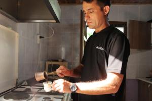 a man in a kitchen preparing food on a stove at KiDRAK OTEL MONTENEGRO-1 in Faralya