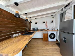 a kitchen with a wooden counter and a refrigerator at Domaine du Val in Vieux-Habitants