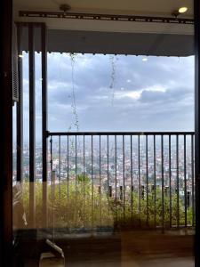 a large window with a view of a city at Oak Room Ở Space Ecopark in Kim Quan