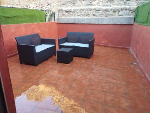 two chairs sitting on top of a patio at Apartamentos calatorao con jardín y 3 habitaciones in Calatorao
