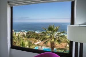 a room with a window with a view of the ocean at NH Iquique Costa in Iquique
