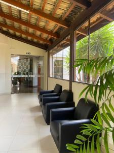 a waiting room with blue couches in a building at Vale dos Carajás Hotel in Parauapebas