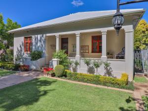 a white house with a gate and a yard at 15 On Le Roux in Robertson +9 photos