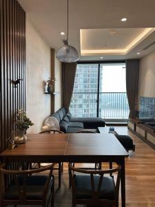 a living room with a table and a couch at Mizu Room Ecopark panorama view in Kim Quan