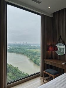 a room with a large window with a view of a river at Mizu Room Ecopark panorama view in Kim Quan