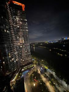 a view of a tall building at night at Mizu Room Ecopark panorama view in Kim Quan