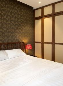 a bedroom with a white bed and a red lamp at Mizu Room Ecopark panorama view in Kim Quan +8 photos